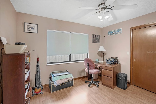 home office featuring ceiling fan and light hardwood / wood-style flooring