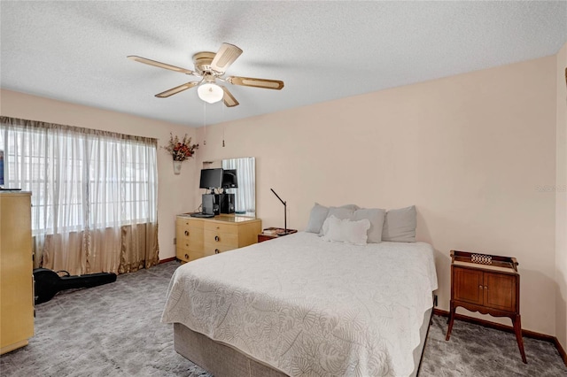 carpeted bedroom with a textured ceiling and ceiling fan