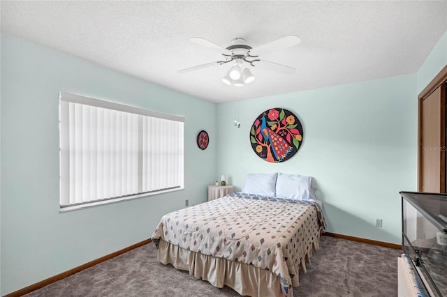 carpeted bedroom with a textured ceiling and ceiling fan