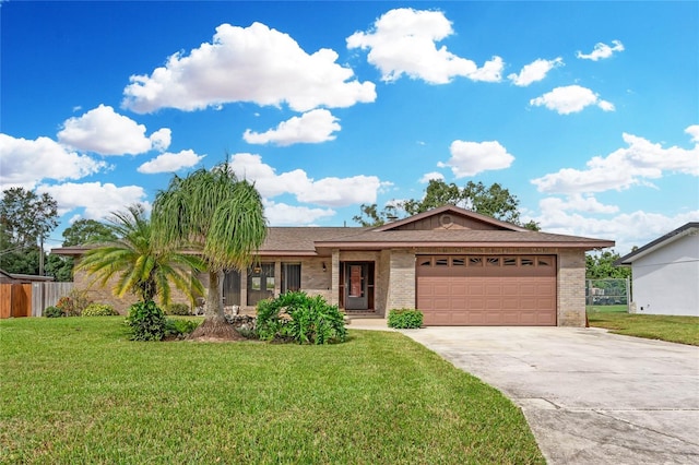 ranch-style house featuring a garage and a front lawn