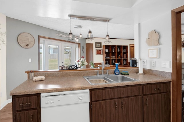 kitchen with sink, decorative light fixtures, french doors, white dishwasher, and dark brown cabinets