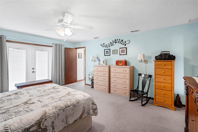 carpeted bedroom with a textured ceiling and ceiling fan