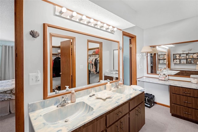 bathroom with vanity and a textured ceiling