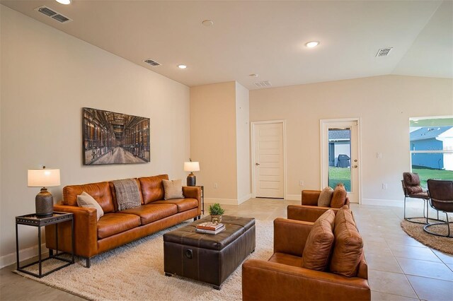 tiled living room featuring vaulted ceiling