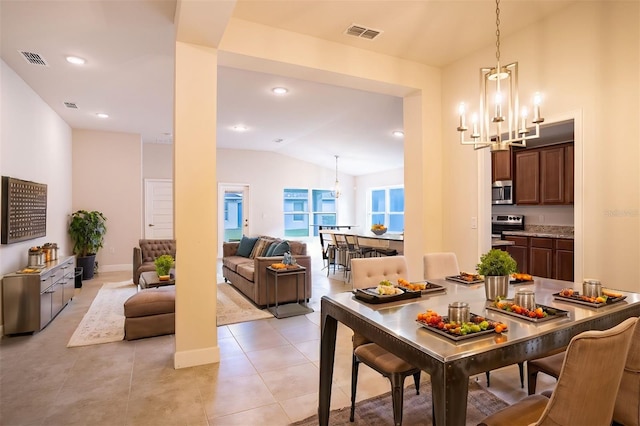 tiled dining area featuring lofted ceiling and an inviting chandelier