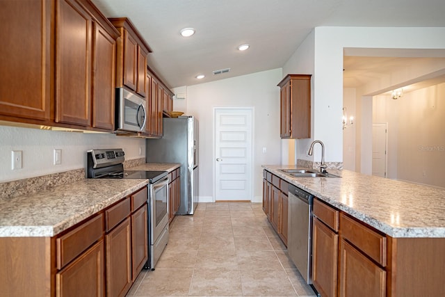kitchen with sink, light tile patterned flooring, appliances with stainless steel finishes, and lofted ceiling