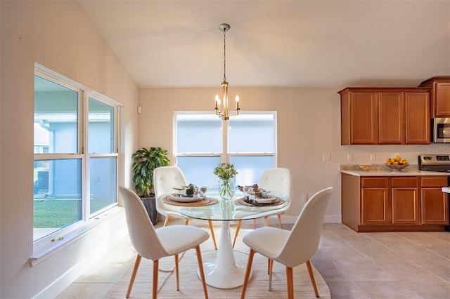 dining room featuring an inviting chandelier and light tile patterned floors