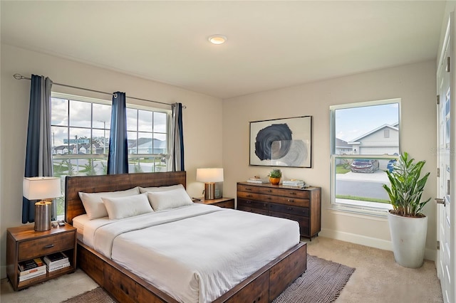 carpeted bedroom with multiple windows