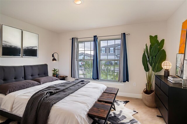 bedroom featuring light colored carpet