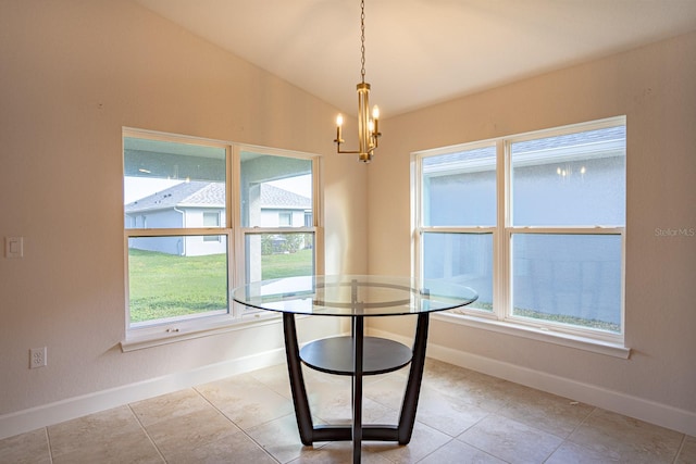 unfurnished dining area with light tile patterned flooring, a chandelier, and vaulted ceiling