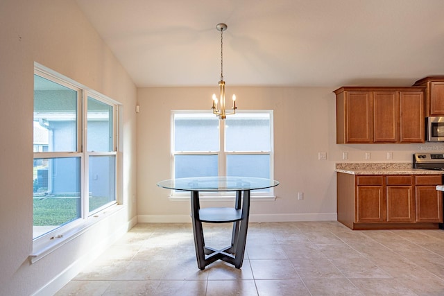 dining area with light tile patterned flooring and a chandelier