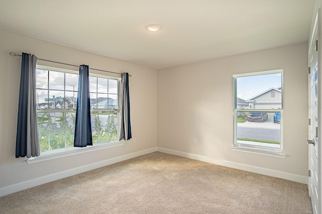 carpeted spare room with plenty of natural light
