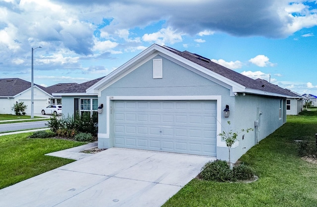 ranch-style house with a garage and a front lawn