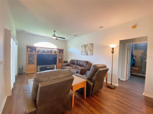 living room featuring dark hardwood / wood-style flooring and ceiling fan