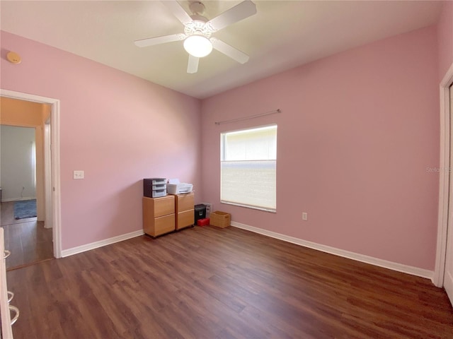 unfurnished room featuring ceiling fan and dark hardwood / wood-style flooring