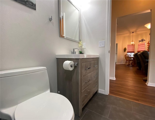 bathroom with toilet, hardwood / wood-style floors, and vanity