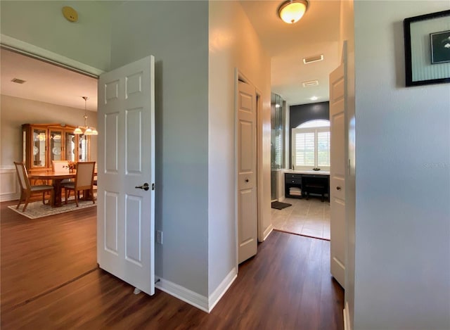 hallway with dark hardwood / wood-style floors