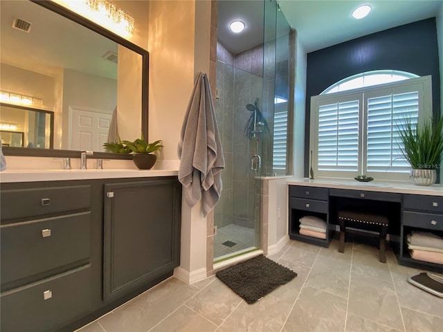 bathroom with vanity and a shower with door