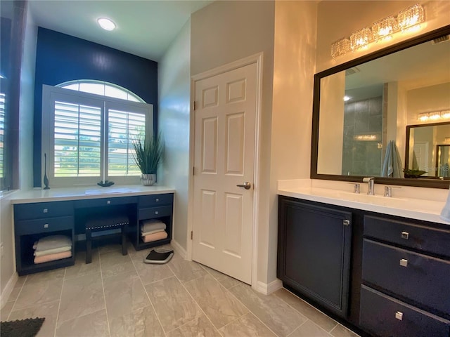 bathroom with vanity and a shower