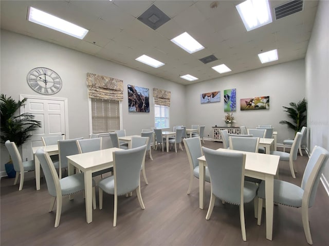 dining area featuring dark wood-type flooring