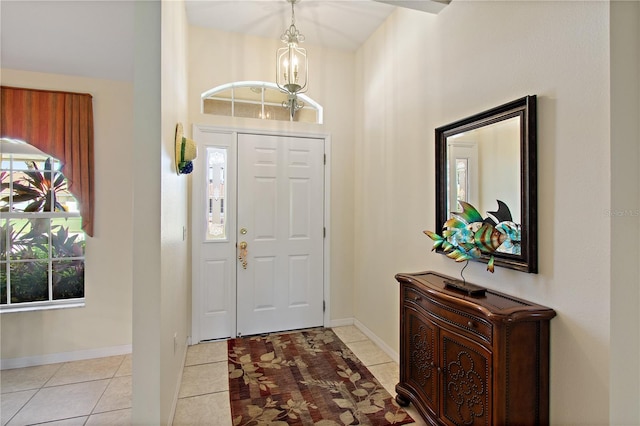 tiled foyer with a notable chandelier