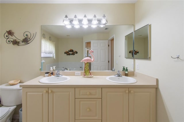 bathroom featuring toilet and vanity