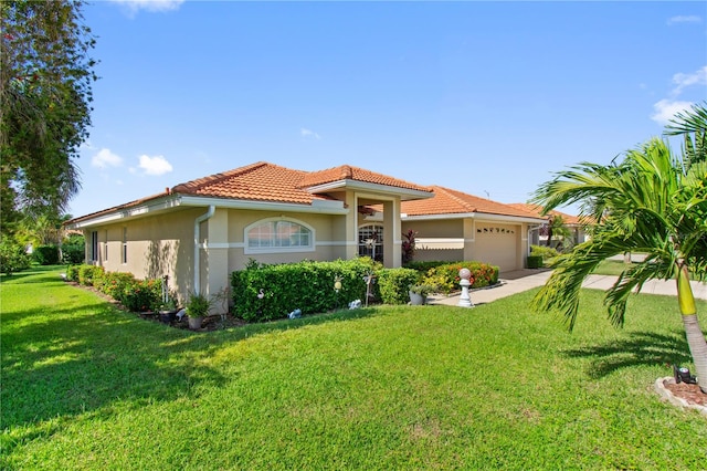 mediterranean / spanish-style house featuring a front lawn and a garage