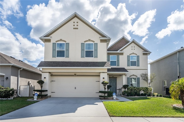 view of front of house with a front yard and a garage