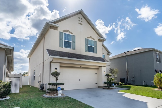 front of property with central AC, a front yard, and a garage