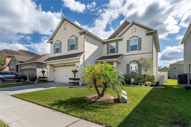 view of front of house with a front lawn, central AC unit, and a garage