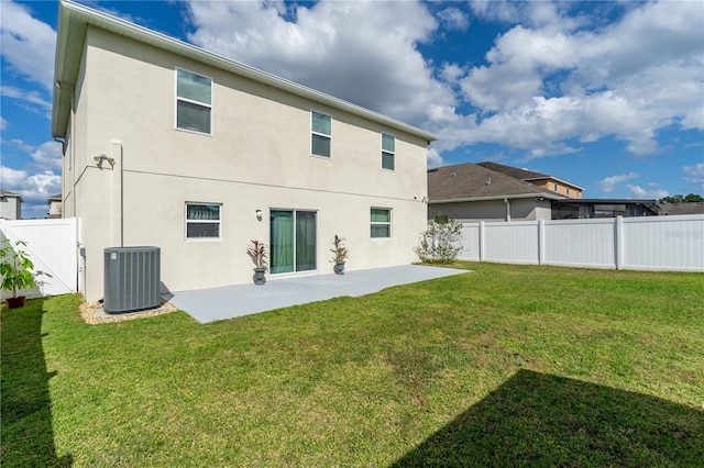 back of house with a patio, central AC unit, and a lawn