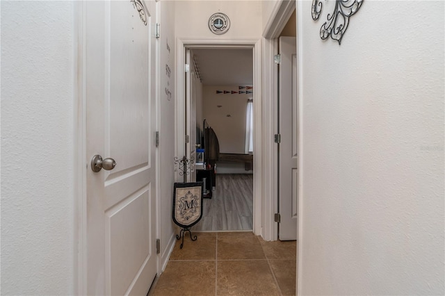 corridor featuring light tile patterned floors