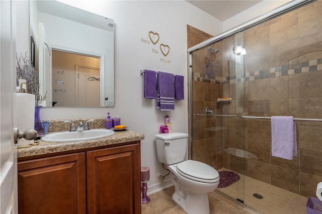 bathroom with vanity, toilet, tile patterned floors, and an enclosed shower