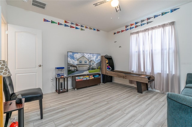 living area with light hardwood / wood-style flooring and ceiling fan