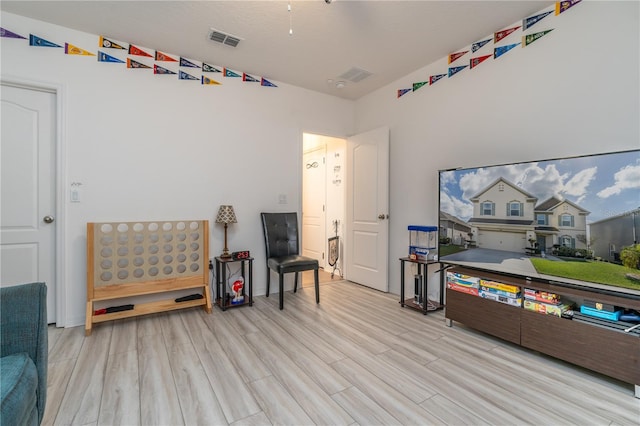 playroom with light hardwood / wood-style flooring