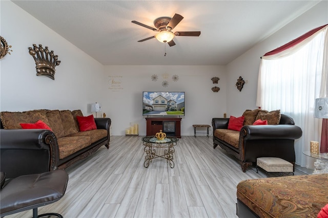 living room with light hardwood / wood-style floors and ceiling fan