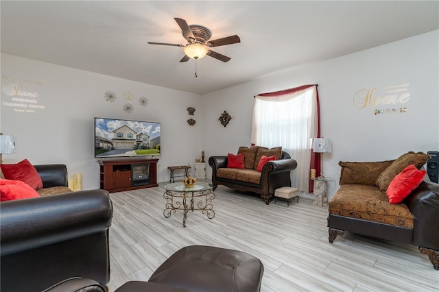 living room featuring light wood-type flooring and ceiling fan