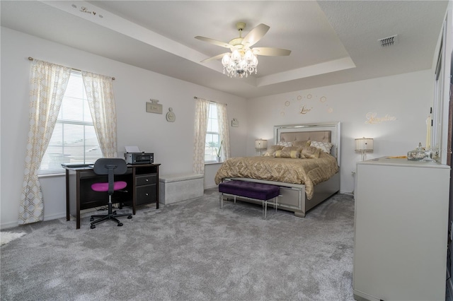 bedroom featuring ceiling fan, light carpet, and multiple windows