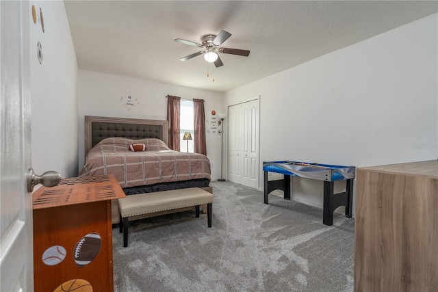 carpeted bedroom featuring a closet and ceiling fan