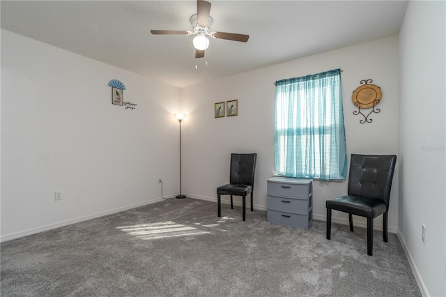 living area featuring carpet flooring and ceiling fan