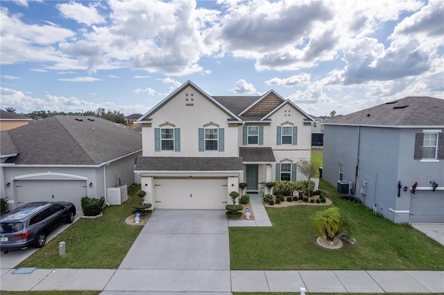 front of property featuring a front yard, a garage, and central air condition unit