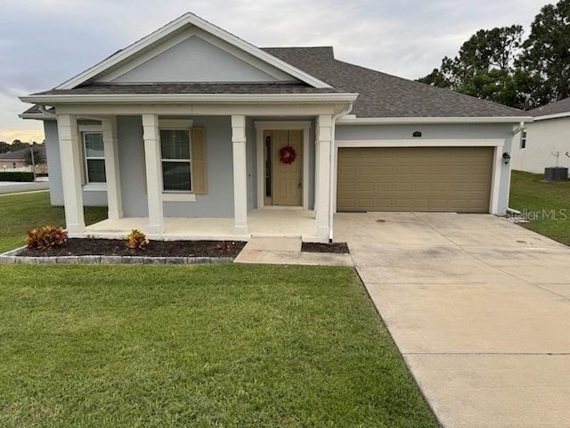 view of front facade featuring covered porch, a front lawn, and a garage