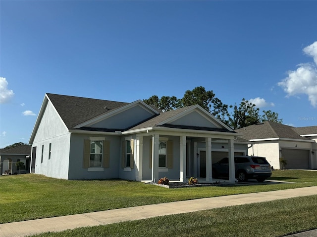 view of front of home featuring a front yard and a garage