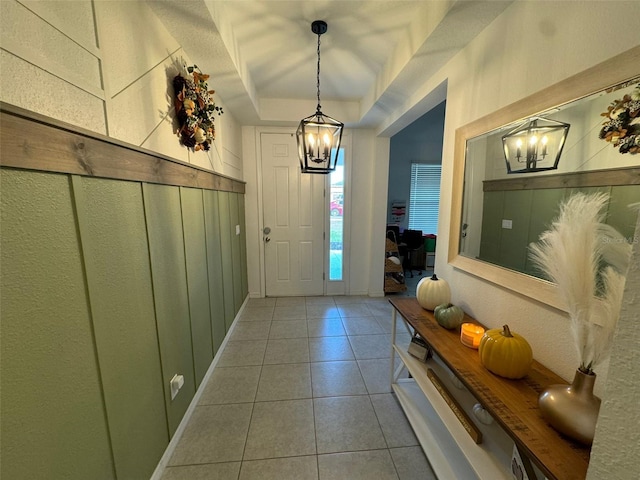 entryway featuring a tray ceiling and tile patterned flooring