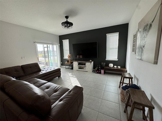 tiled living room featuring a textured ceiling