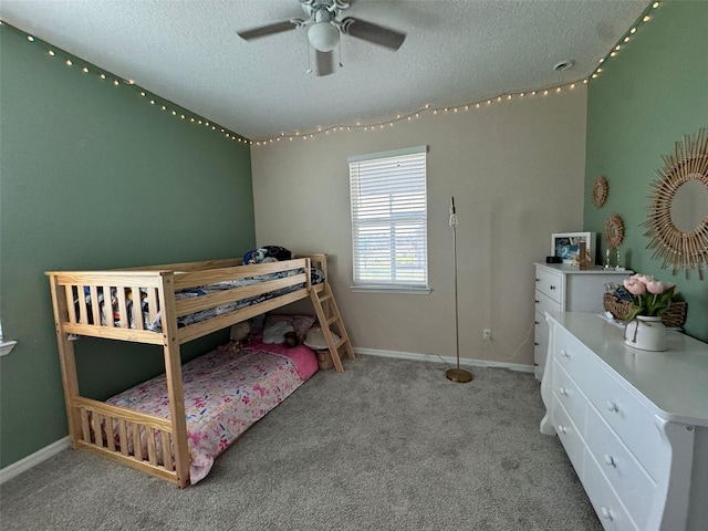 bedroom with light carpet, a textured ceiling, and ceiling fan