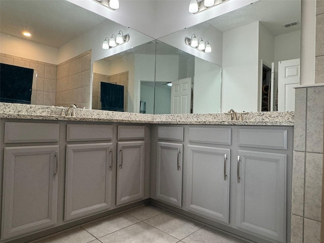 bathroom with vanity, a shower, and tile patterned flooring