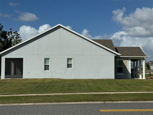 view of side of home featuring a lawn