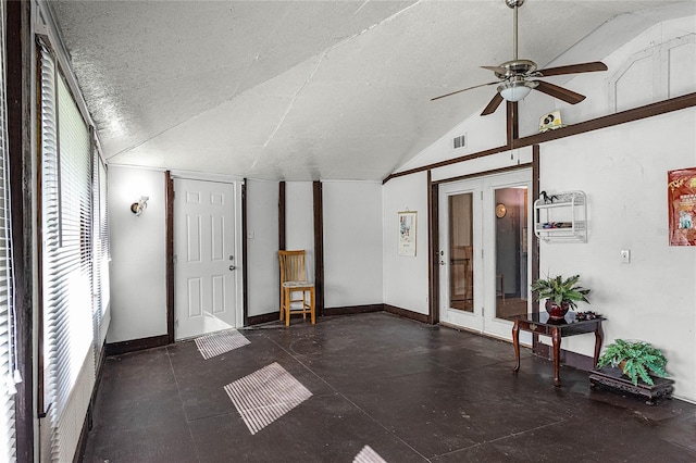 interior space with a wealth of natural light, vaulted ceiling, a textured ceiling, and ceiling fan