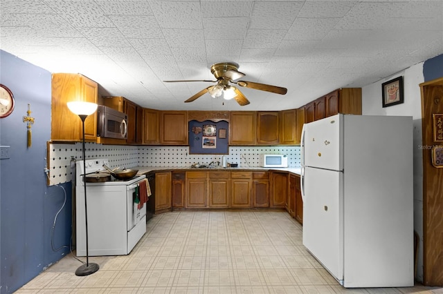 kitchen featuring ceiling fan and white appliances